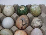 many different colored eggs in a carton on the table