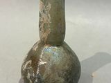 a green vase that is sitting on a table