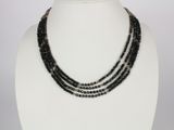 a close up of a necklace on a mannequin mannequin