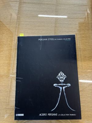 a book that is sitting on a table in a glass case