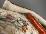 a close up of a vase with a handle on it