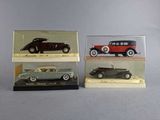 three model cars are displayed in a display case on a table