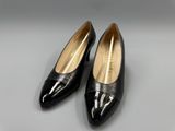 a pair of black shoes on a gray surface