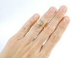 a woman ' s hand with a diamond ring on it