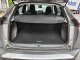 the back of a car with its trunk open and the back seats folded down