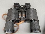 a pair of binoculars sitting on a table next to a cell phone