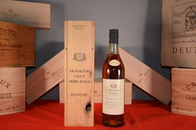 a bottle of wine sitting next to some wooden boxes