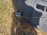 a close up of a car ' s front bumper with a wire attached to it