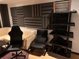 a living room with a couch, chair, bookshelf and a television
