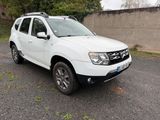 a picture of a white dacia parked in a parking lot
