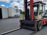 a forklift that is sitting in the middle of a parking lot