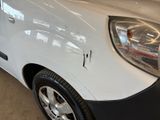a white van with a black stripe parked in a garage