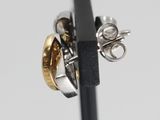 a close up of a pair of silver and gold rings
