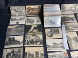 several old black and white photographs of buildings and buildings on a table
