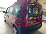 a red van that is parked in a garage
