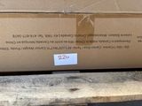 a cardboard box with a price label on it sitting on a pallet