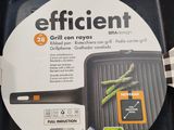 an image of a black grill pan with a handle and a sticker on it