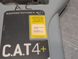 a close up of a cat 4 and a radio on a table