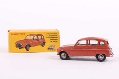 an old red toy car sitting next to a box on a white surface