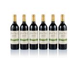 four bottles of wine are lined up on a white surface
