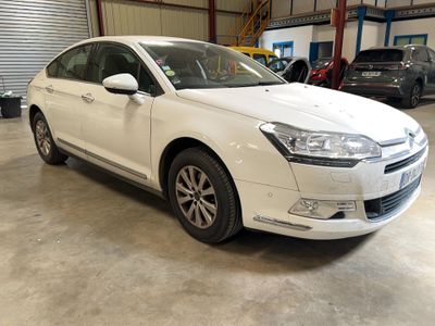 a picture of a white citrole parked in a garage