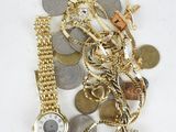 a pile of gold and silver jewelry on a white surface
