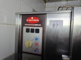 a machine that is sitting in a kitchen next to a wall