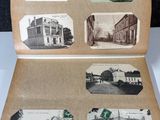 an old photo of an open book with pictures of buildings on it