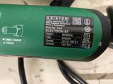 a close up of a green electric motor on a table