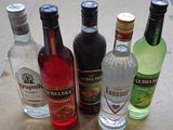 bottles of different types of alcohol lined up on a table