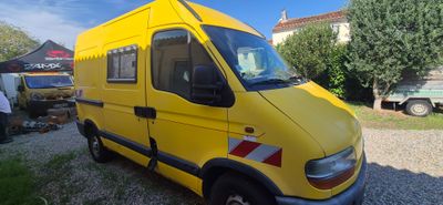 a yellow van that is parked in a lot