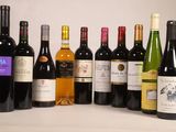 many bottles of wine that are lined up on the table