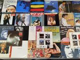 a lot of different album covers on a table