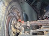a close up of a vehicle ' s front wheel and axle