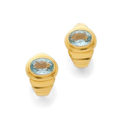 a pair of gold and aquamarinee earrings