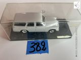une petite voiture miniature dans une boîte transparente avec une étiquette de prix