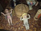 some figurines are sitting on top of a table next to a vase
