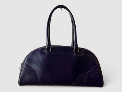 un sac à main en cuir noir sur fond blanc
