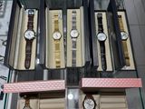 a glass display case with several watches on it