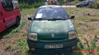 a green car that is parked in the grass
