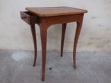 a small wooden table with a drawer on it