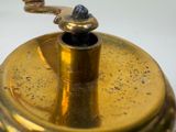 a close up of a brass teapot on a white table