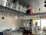 a bar with a lot of wine glasses on the shelves