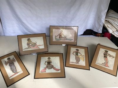 six framed pictures of a woman with a surfboard on a table