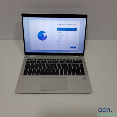 an open laptop computer sitting on top of a white table