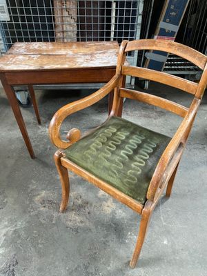 a chair that is sitting next to a table