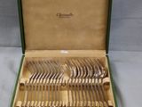 a green box with a set of silverware in it