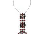 a close up of a necklace on a white background