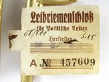 an old brass plate with a note attached to it