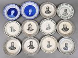 several plates with portraits of men and women on them on a table